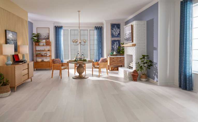 grey wood look flooring in modern living room with blue accent colours and wood decor