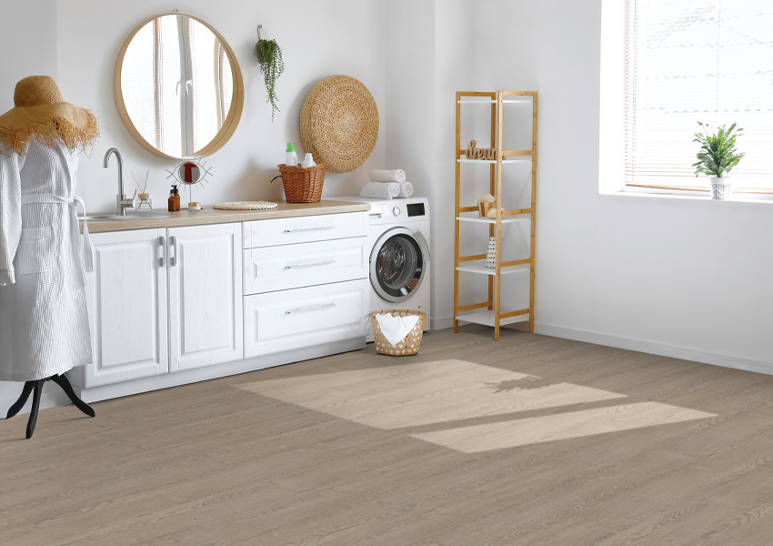 wood-look laminate flooring in bathroom with white cabinets and boho decor