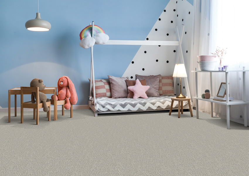 grey carpet in kid's bedroom with stuffed animals.